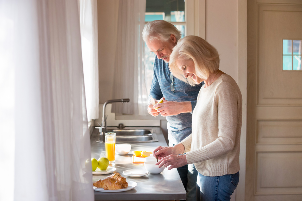 Man and woman preparing food in kitchen