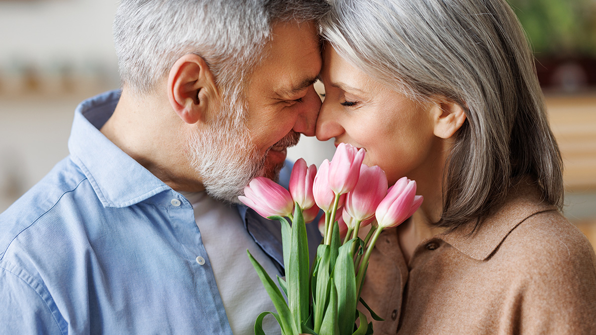 Happy couple holding tulips