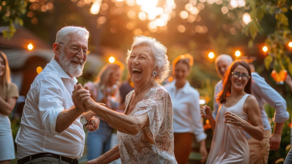 An elderly couple enjoying a dance at a garden party, surrounded by friends and family